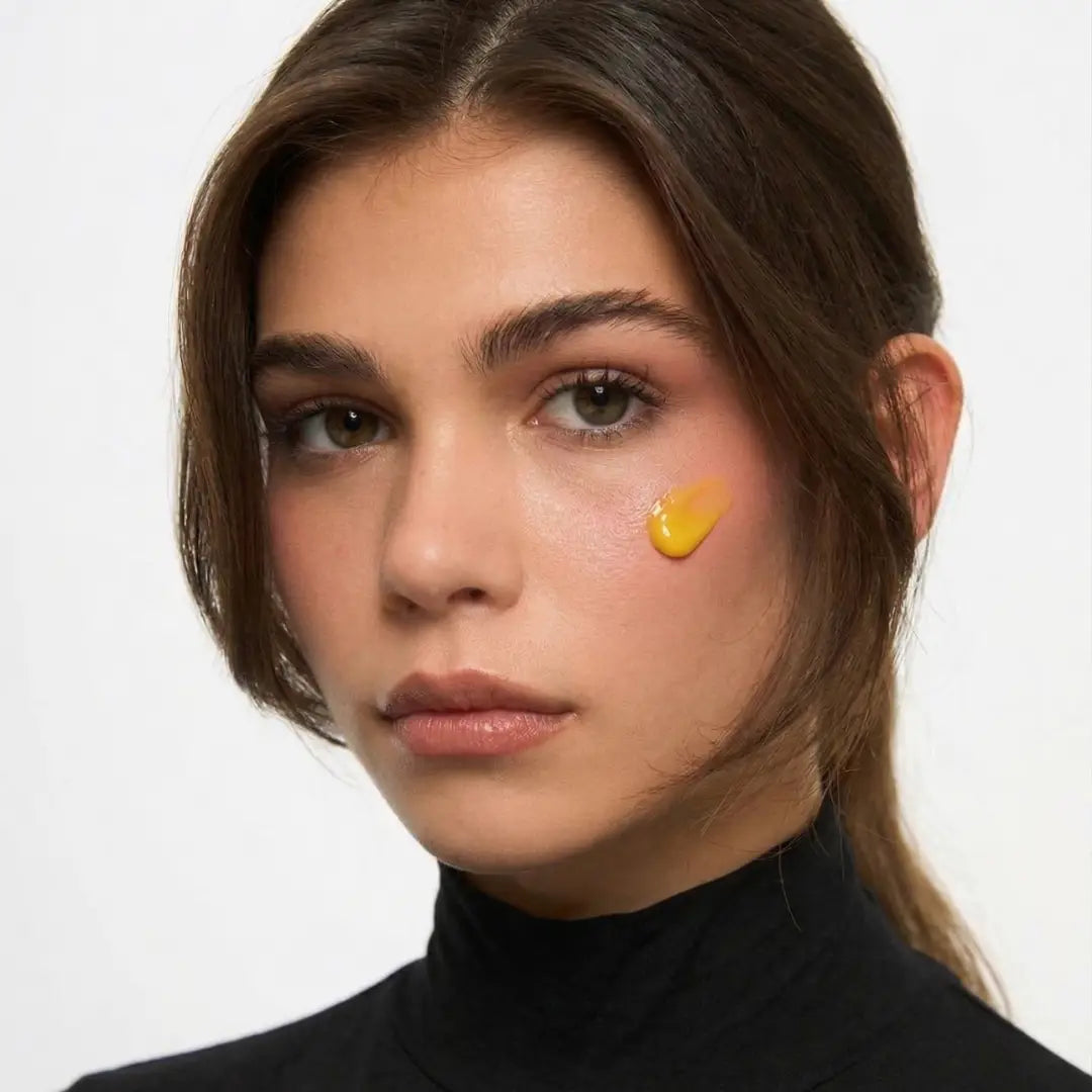 Young woman holding a bottle of By Valenti Bakuchiol Retinol Alternative Smoothing Serum