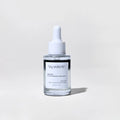 Skincare serum bottle with dropper labeled 'by valenti' on a light gray background
