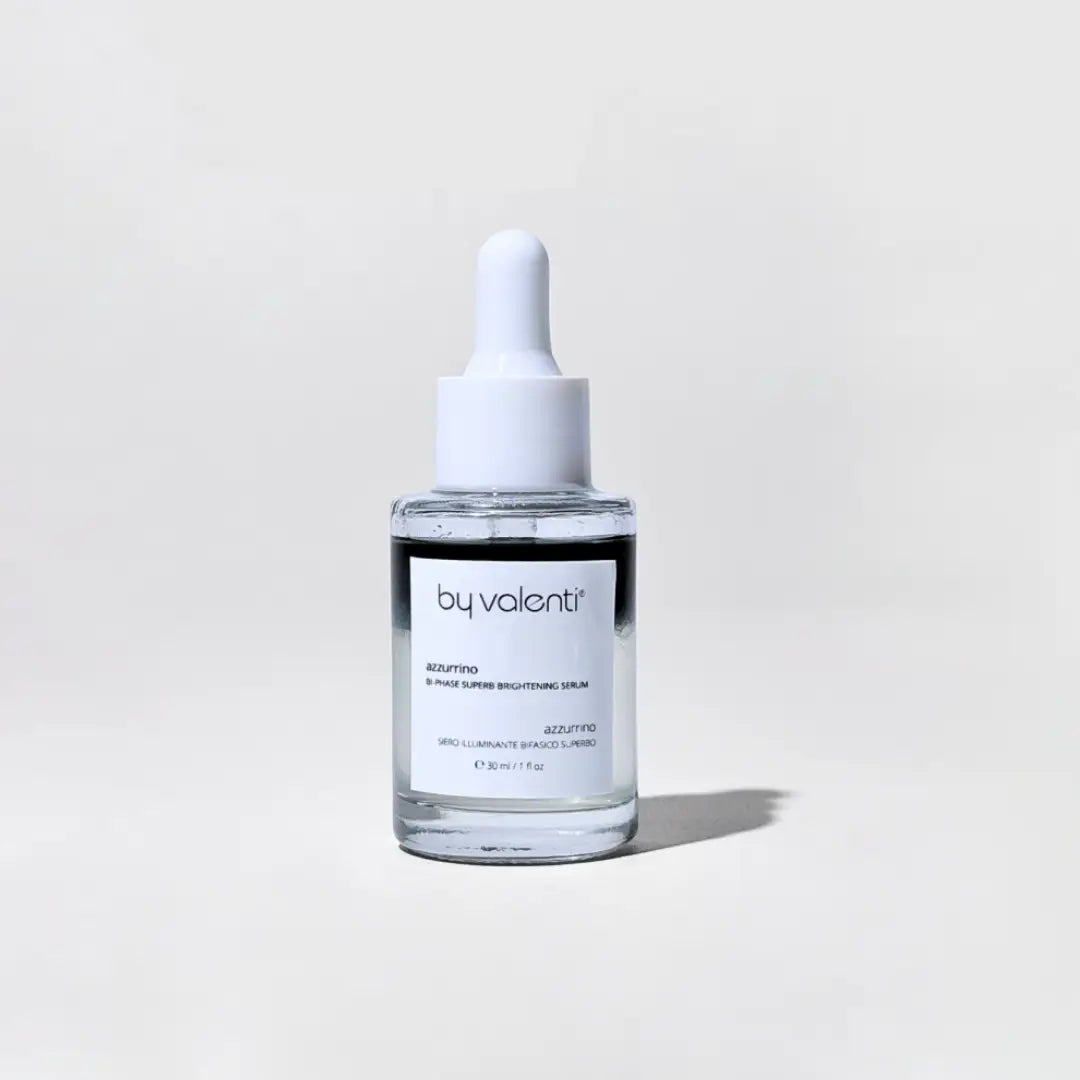 Skincare serum bottle with dropper labeled 'by valenti' on a light gray background