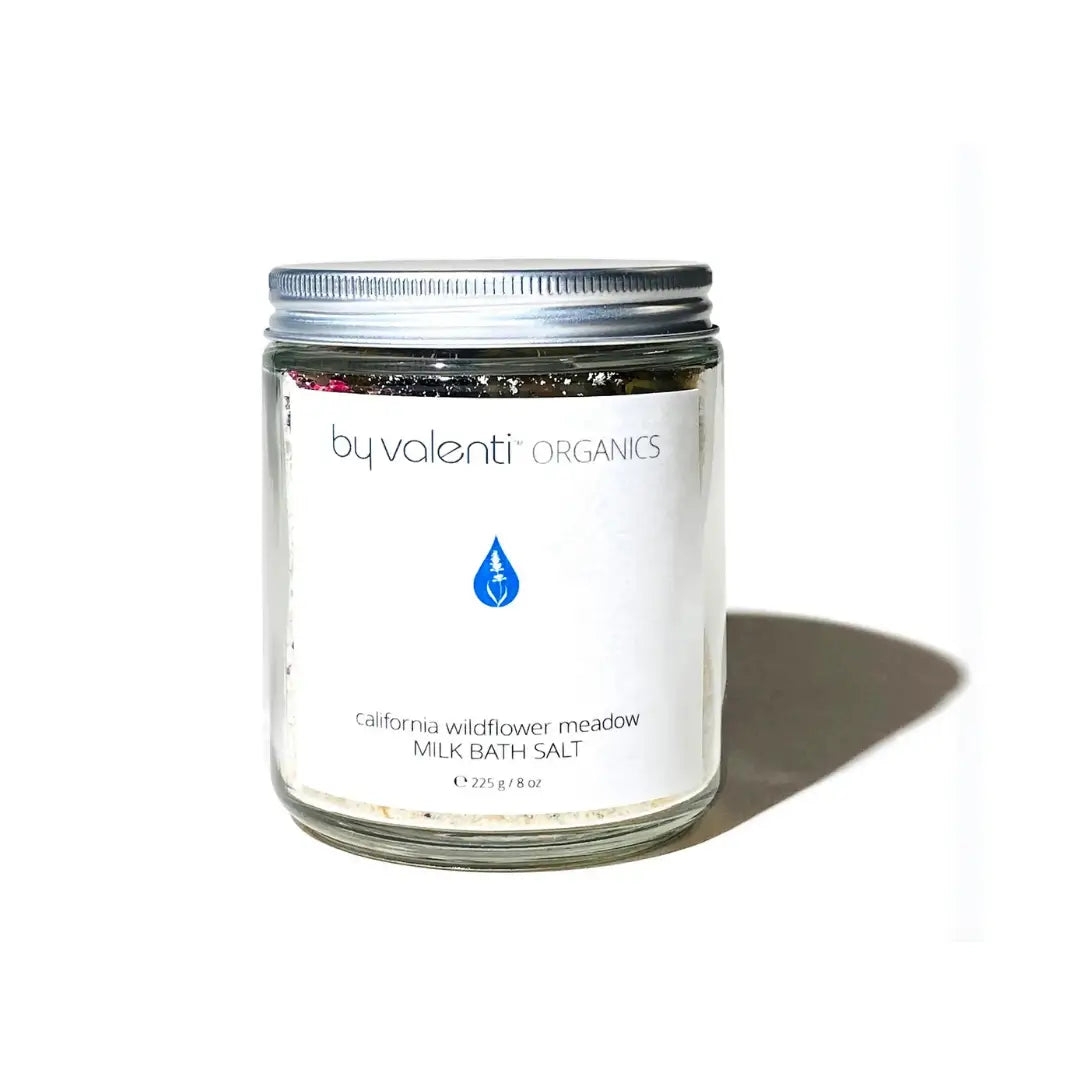 By Valenti jar of wildflowers and goat's milk bath salt on a white background