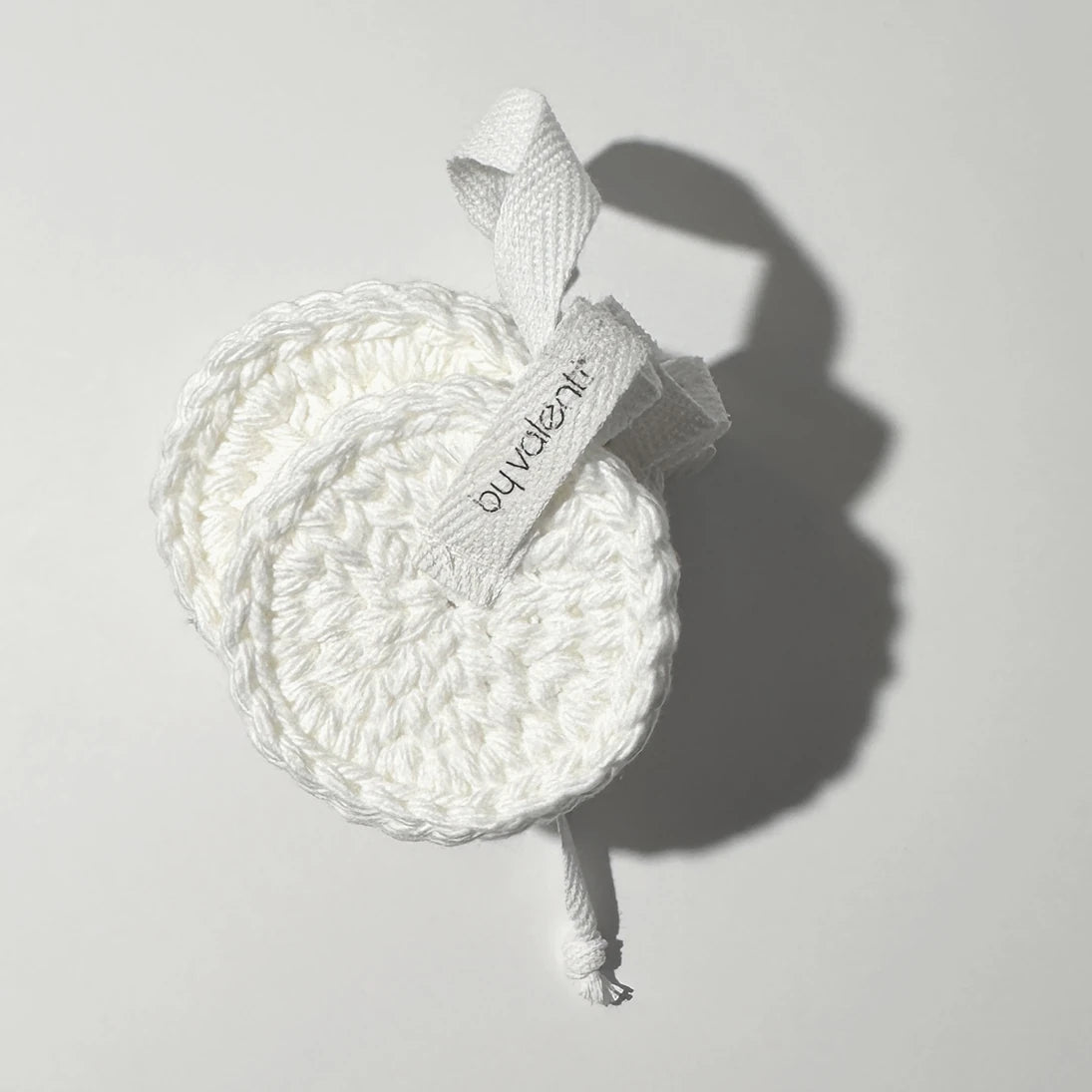 By Valenti handmade white face cotton pad set of face cleansing rounds on a light gray background