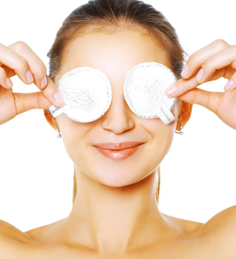 Woman using By Valenti handmade crochet white cotton pads to remove makeup