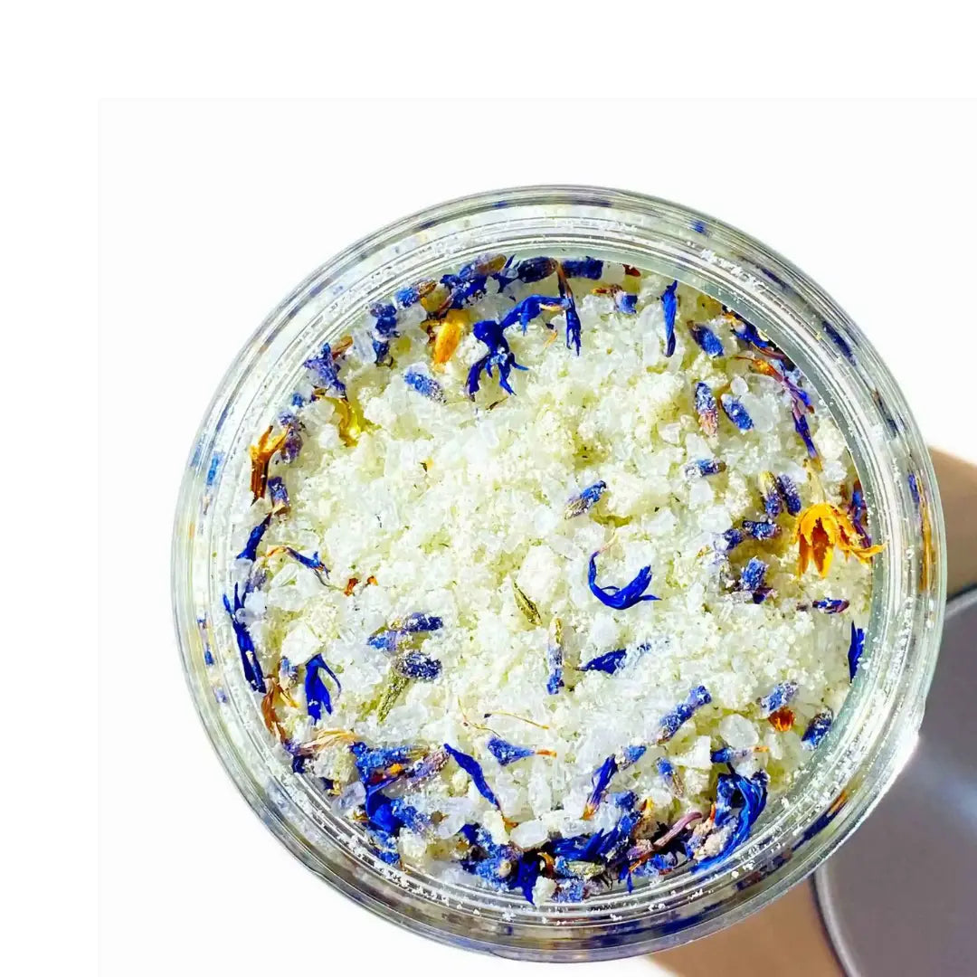 By Valenti jar of bath salts and goat's milk with colorful lavender flowers on a white background