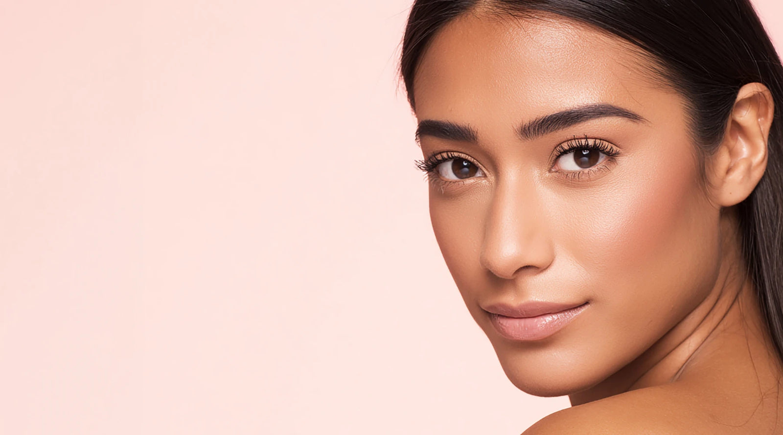 Woman with a smooth complexion on a pink background