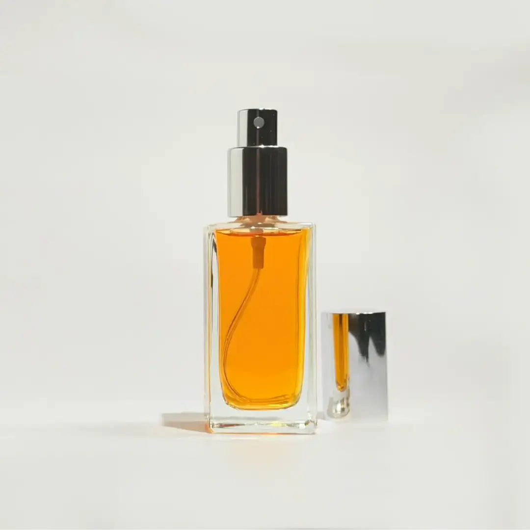 By Valenti New Trieste perfume bottle with orange perfume on a white background