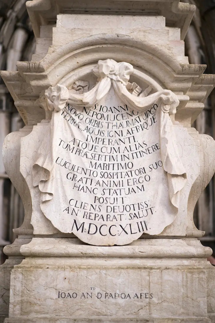 Stone monument with engraved text in an architectural setting